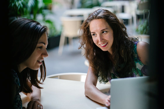 Two women looking up website SEO services
